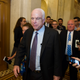 Senator John McCain, the Arizona Republican who cast the deciding ‘no’ vote, is pursued by reporters after the vote.